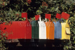 Colorful mailboxes line up in a row displaying their flags in Santa Barbara, California. To purchase this image, please go to my stock agency click here.