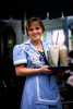 A restaurant waitress in San Diego, California carries a tray full of milk shakes. To purchase this image, please go to my stock agency.