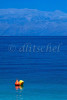 A deep blue ocean and sky with an orange and yellow buoy in the foreground in the Peloponnese located in the southern area of Greece. To purchase this image, please go to my stock agency click here.