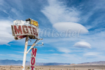 The Rustic Oasis Motel sign with a lenticular cloud formation behind it. The Rustic Oasis Motel is an American roadside attraction along California highway 395 in the Eastern Sierra. Lenticular clouds (Altocumulus lenticularis in Latin) are stationary clouds that form in the troposphere, typically in perpendicular alignment to the wind direction. They are often comparable in appearance to a lens or saucer. Because of their unique appearance, they have been brought forward as an explanation for some unidentified flying object UFO sightings.