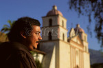 A padre pauses in early morning light outside of the Santa Barbara Mission, known as the {quote}queen of the missions{quote} in California. To purchase this image, please go to my stock agency.