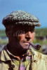 Siberian middle aged adult in wool hat smoking pipe, Krasnoyarsk Krai region of Siberia. To purchase this image, please go to my stock agency click here.