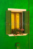 A brilliant green wall in Burano Island, Italy frames a gold refection in the window. To purchase this image, please go to my stock agency click here.