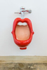 A red lips urinal with white teeth in the men's bathroom at the Collector Car Vault in Santa Paula, California. The urinal was originally designed in 2000 by Dutch designer Meike van Schijndel.