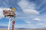 The Rustic Oasis Motel sign with a lenticular cloud formation behind it. The Rustic Oasis Motel is an American roadside attraction along California highway 395 in the Eastern Sierra. Lenticular clouds (Altocumulus lenticularis in Latin) are stationary clouds that form in the troposphere, typically in perpendicular alignment to the wind direction. They are often comparable in appearance to a lens or saucer. Because of their unique appearance, they have been brought forward as an explanation for some unidentified flying object UFO sightings.