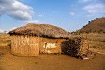 Traditional Masai house constructed of cow dung and mud with interwoven branches for support in Sinya area of northern Tanzania. The Masai women are responsible for the construction of the houses. To purchase this image, please go to my stock agency click here.