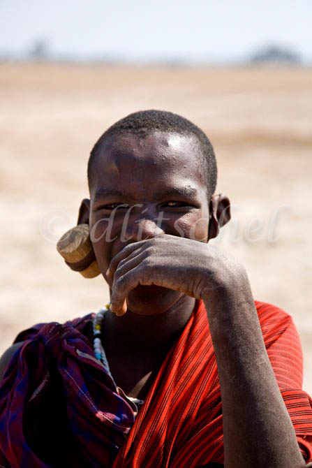 A young Masai warrior pauses in the Sinya area of northern Tanzania in East Africa. To purchase this image, please go to my stock agency click here.