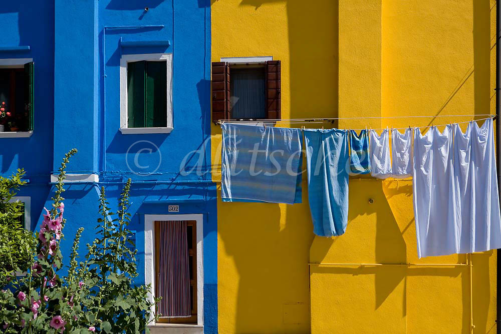 Drying laundry in the colorful fishing village of Burano, Italy, located on Burano Island, a short commute by Vaporetto (water taxi) from Venice, Italy.To purchase this image, please go to my stock agency click here.