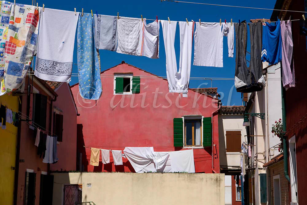 Laundry Drying in the colorful fishing village of Burano, Italy, located on Burano Island, a short commute by Vaporetto (water taxi) from Venice, Italy. To purchase this image, please go to my stock agency click here.