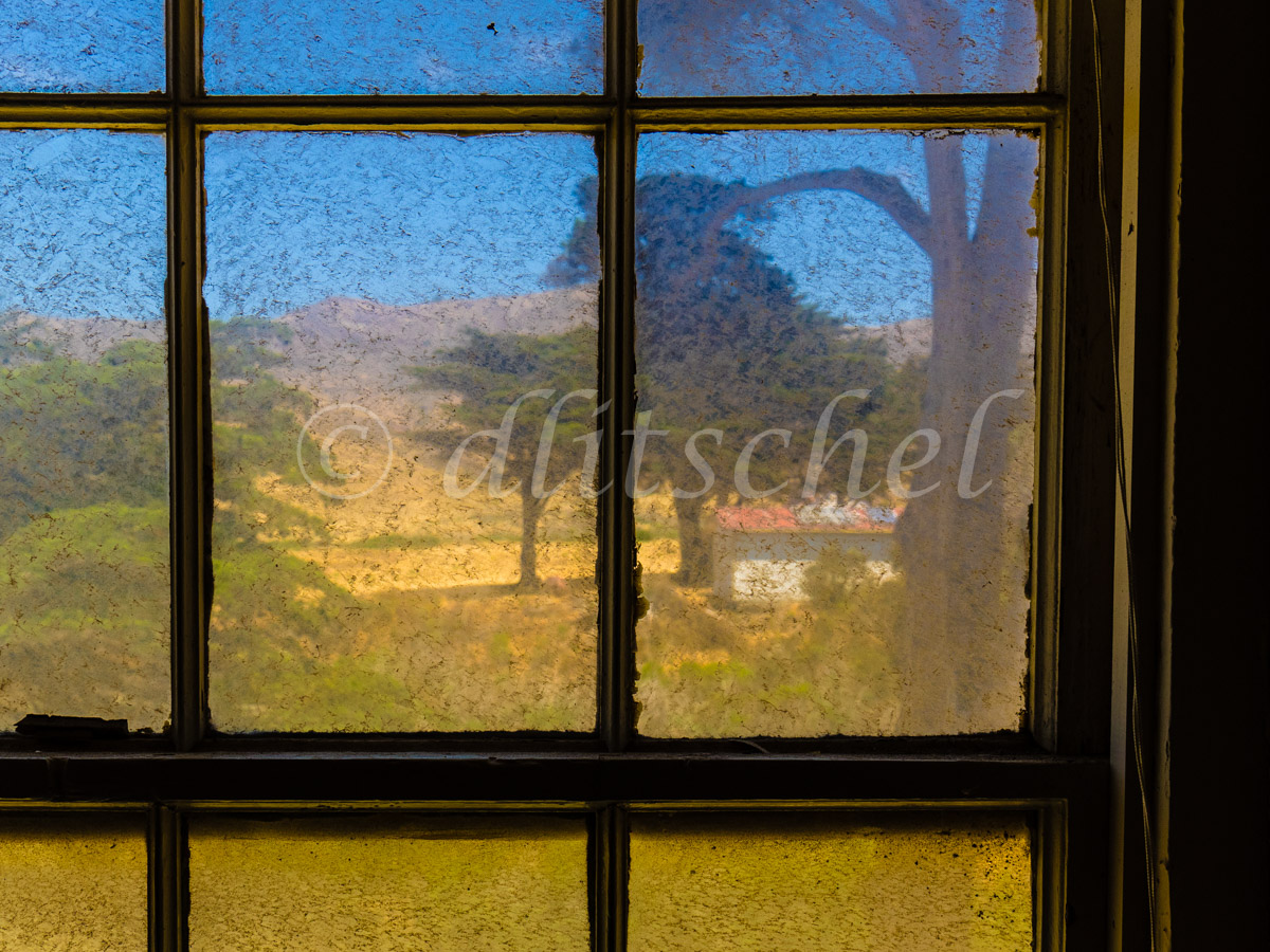A view outside through a very dirty window of the bunkhouse on Santa Cruz Island on the Christy Ranch property on the island\'s west end. 