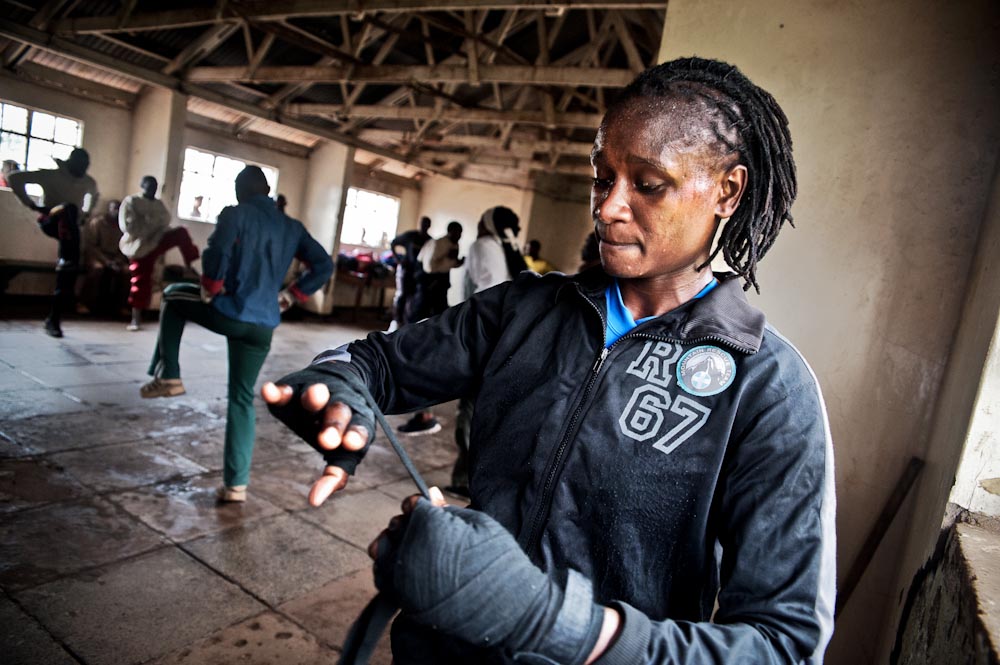 Sarah Achieng Ndisi re wraps her wrists during sparring at Kariobangi Community Centre. Sarah is a Boxgirls graduate and coach. She is currently the best professional female boxer in East Africa under the feather weight category.