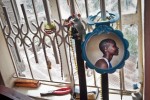 A portrait of Sonko in her bedroom as her fashion accessories hang off the burglar bars. Sonko shares 1 bed with her two younger sisters in Nairobi’s Eastlands slum area.