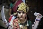 Along side the worship, various socio-religious functions take place, such as competitions for the best dancer or the best dressed individual. A girl stands to be judged for 'the best dressed, goddess' at Jalaram Temple Nairobi.