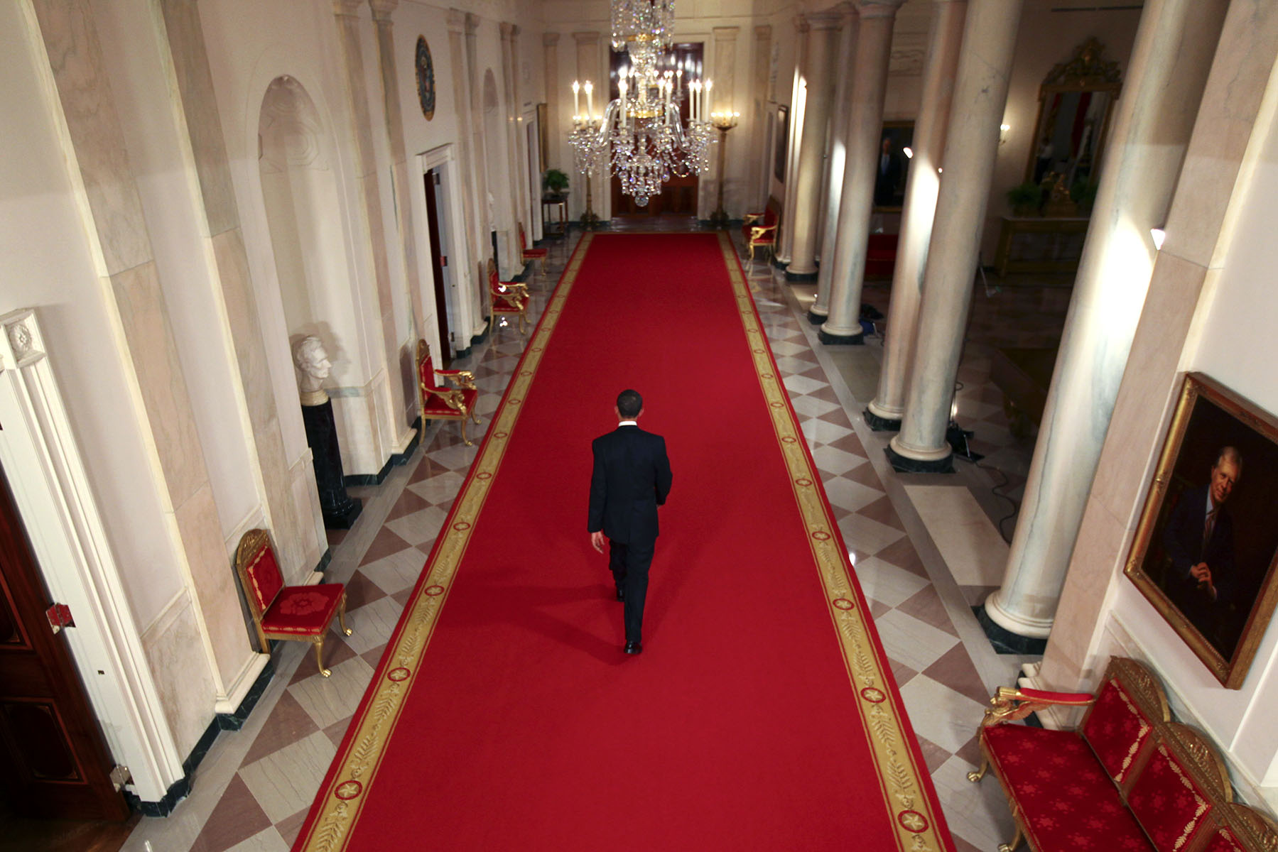 President Barack Obama walks down the Cross Hall at the end of a news conference in the East Room of the White House in Washington, DC.Photo by Brooks Kraft/Corbis