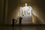 Tourists inside the Lincoln Memorial,  built to honor the 16th President of the United States, Abraham Lincoln.  It is located on the National Mall in Washington, D.C. Photo by Brooks Kraft/Corbis