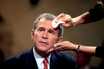 Republican presidential candidate George W Bush gets make up put on before a television interview.