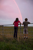 Children watch a rainbow over a farm field on the island of Martha's Vineyard, MA.