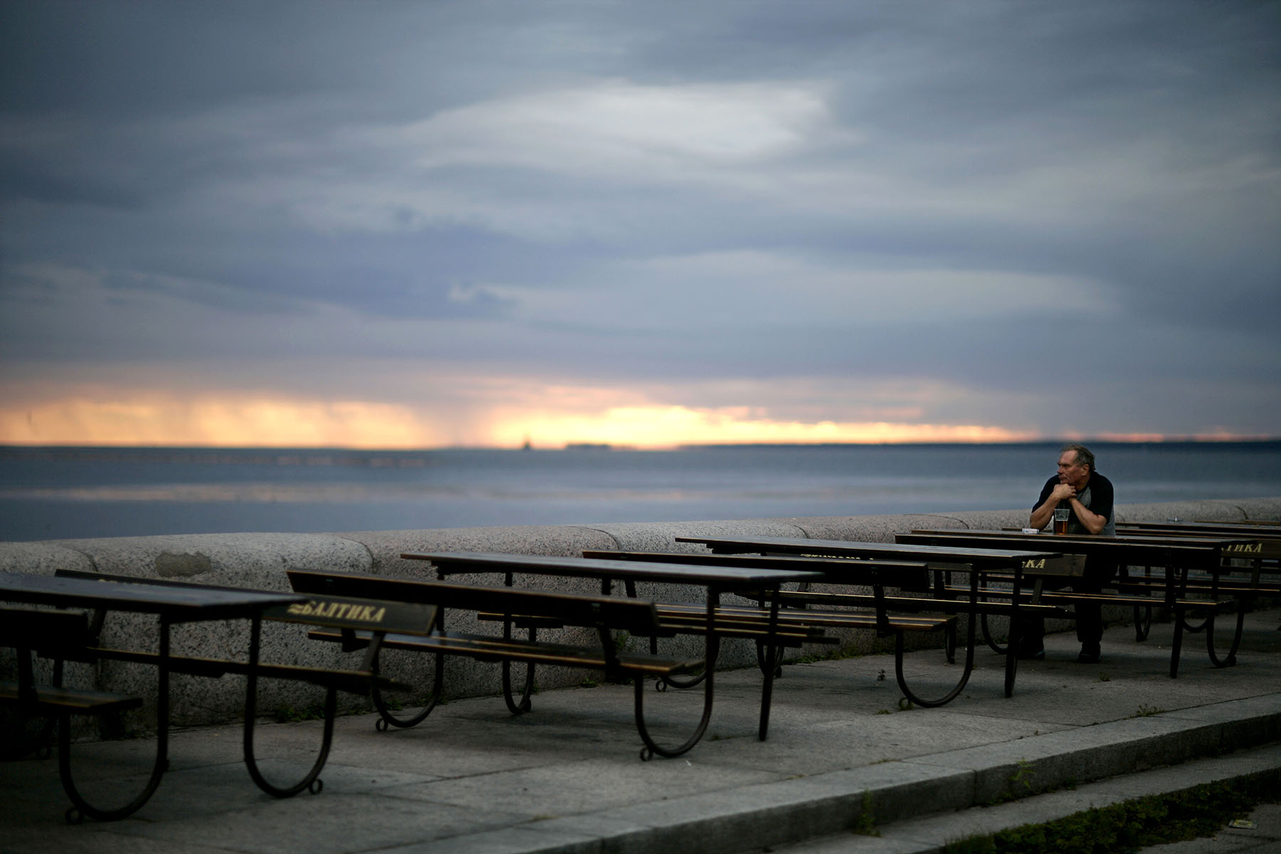 A man drinks a beer at a cafe along the Gulf of Finland in St. Petersburg, Russia, July 17, 2006.Photo by Brooks Kraft/Corbis
