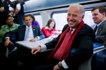 Vice President elect Joe Biden and President-elect Barack Obama speaks with passengers on the train en route to Baltimore, during his inaugural whistle stop train trip to Washington.  Photo by Brooks Kraft/Corbis