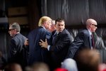 DAYTON, OH - MARCH 12: Republican presidential candidate Donald Trump is surrounded by Secret Service agents during a campaign event on March 12, 2016 in Dayton, Ohio.  The agents were responded to a protestor that had rushed the stage while Trump was speaking.  (Photo by Brooks Kraft/Getty Images)