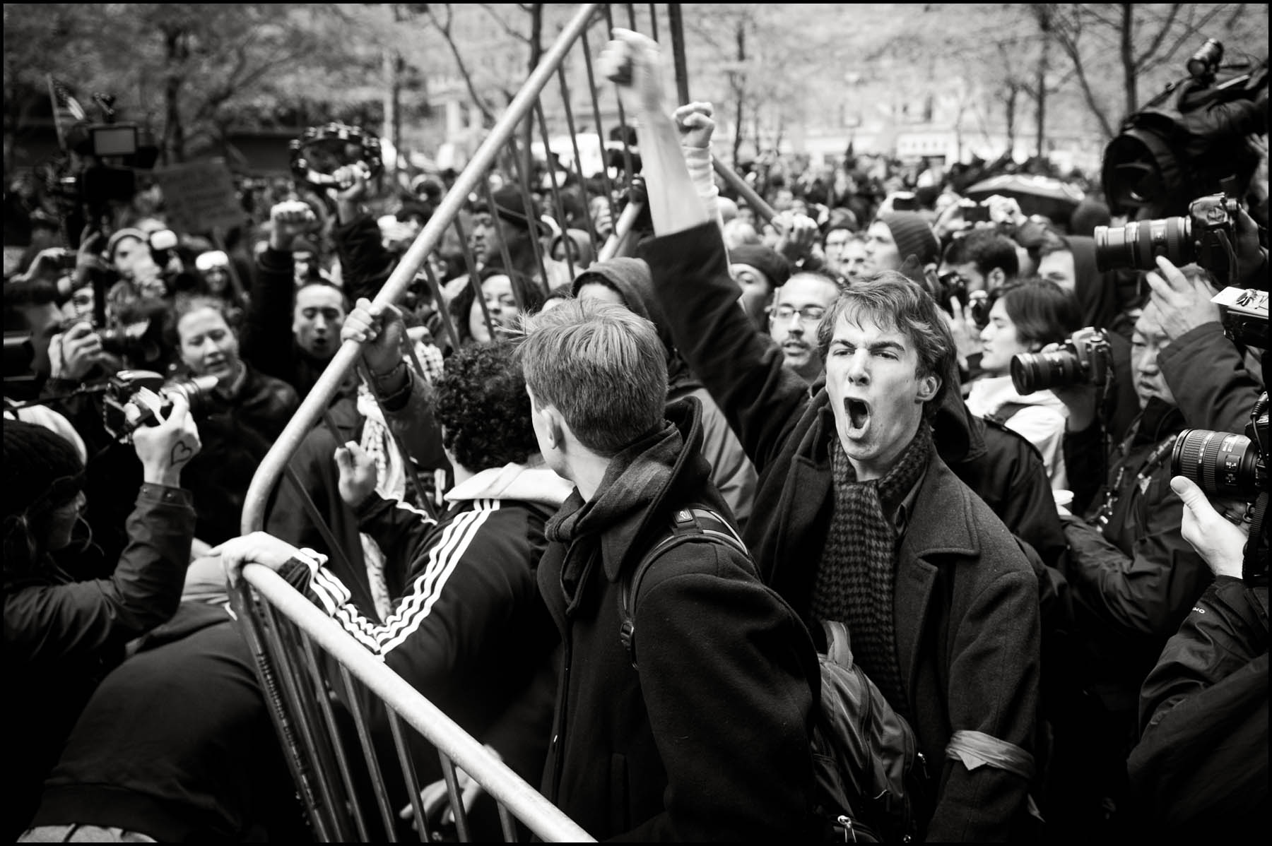 Protesters rip up police barricades in Zuccotti Park during a day of mass action.