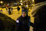 A City of Chicago Police woman faces protestors who are attempting to move onto and block Chicago's Michigan Avenue during demonstrations against the killing of Michael Brown in Ferguson, Missouri.