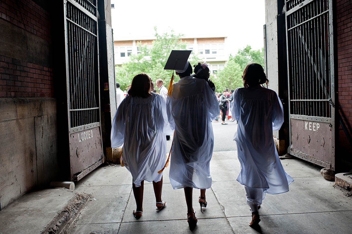 Marshall High School graduates leave the assembly hall by the service entrance after graduation.