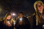 Women participate in a vigil at The First Unitarian Church of Chicago marking the shooting of Michael Brown in Ferguson, Missouri.
