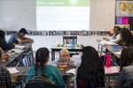 History teacher and college counselor Andrew Johnson speaks with students in his Economics class during a lesson on supply, demand and price relationships at George Westinghouse College Prep, October 6, 2016.