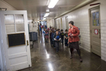 Librarian Lies Garner escorts kindergartners to their homeroom after recess at Hawthorne Scholastic Academy, November 10, 2016.