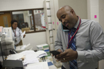 At the end of the day Music Department Chair and Band Director Gerald Powell responds to phone messages in the Music Departments offices at Kenwood Academy High school, November 2, 2016.