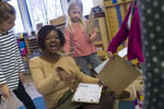 Classroom co-teacher Carmenita Peoples works with several of her students on their work plans in the mixed age class of 6 year-olds to 9 year-olds at the Montessori Academy of Chicago, October 20, 2016.