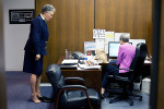 Cook County Board president Toni Preckwinkle does some toe lifts as she speaks to her long-time administrative assitant in her office.
