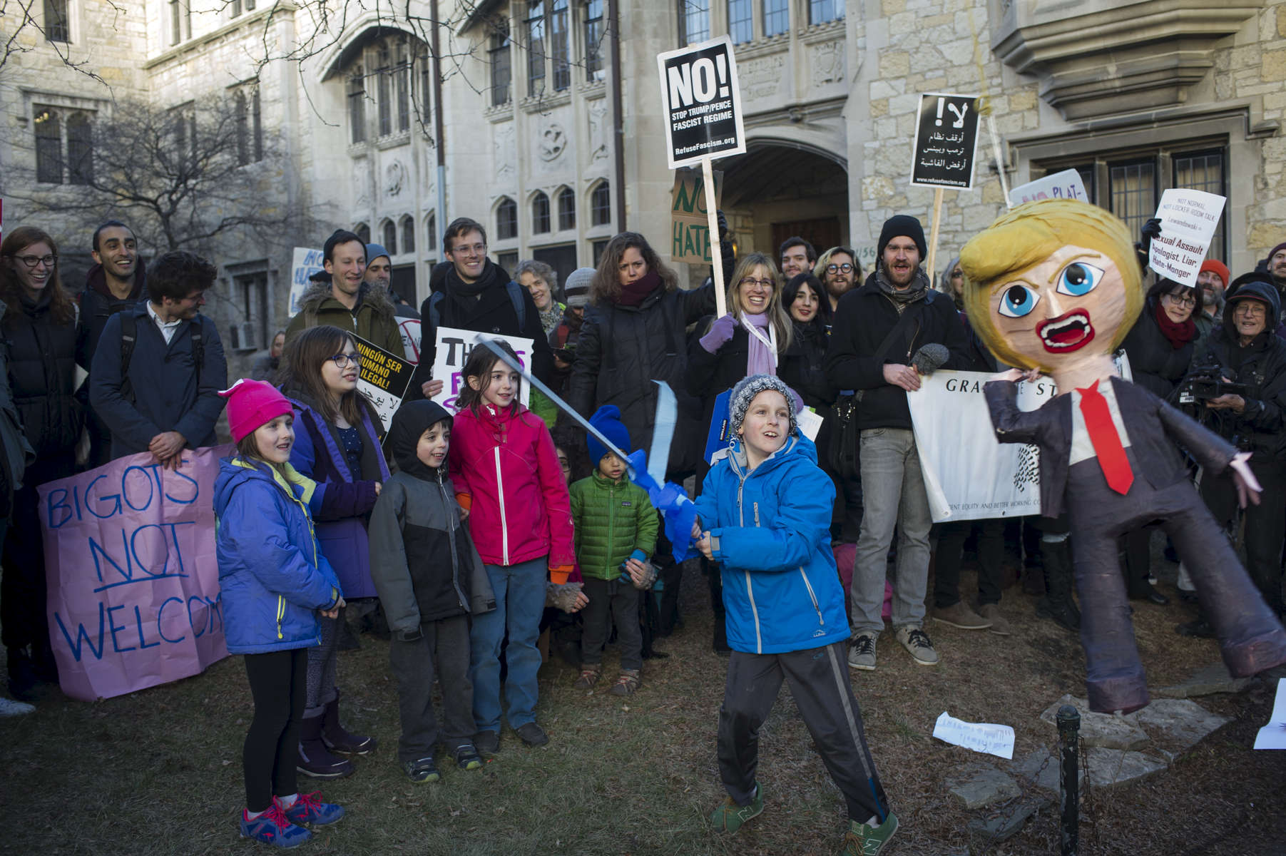 Eight-year-old Luka Vegna-Spofford prepares to decapitate a piñata effigy of Donald Trump on the courtyard lawn of University Church, 5655 S. University Ave., during a demonstration against political operative and former Trump campaign manager Corey Lewandowski as he visits the University of Chicago, Wednesday, February 15, 2017.