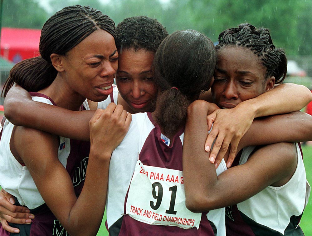 Lower Merion's (names left to right) Avis Hayes, Lorraine Weldon, Dominique Adger (back to camera) and Allison Gibbs celebrate after finishing first in the final girls AAA 4x100 relay competition. 