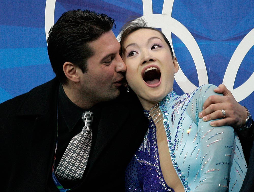 Gold medalist Shizuka Arakawa, of Japan, along with her coach Nikolai Morozov reacts as she sees her scores during the Ladies' free skating program at the 2006 Winter Olympics in Turin, Italy.