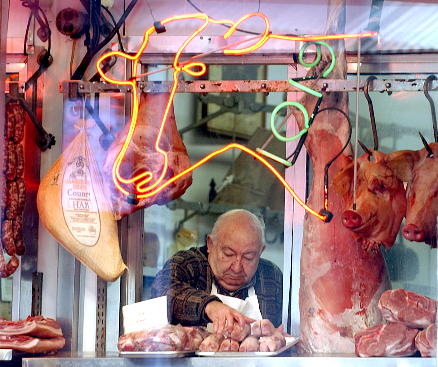 At Cappuccio\'s Meats in the Italian Market, owner Harry Crimi, 79, puts fresh wares in the window on February 20, 2005 in Philadelphia, Pa. Crimi\'s inlaws established the shop in 1920.