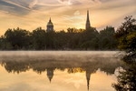 September 12, 2017; View of sunrise from St. Mary's Lake of the Golden Dome and the steeple of the Basilica of the Sacred Heart.  (Photo by Barbara Johnston/University of Notre Dame)