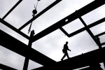 An ironworker walk s on an interior beam on the 47th floor of the Comcast Center.