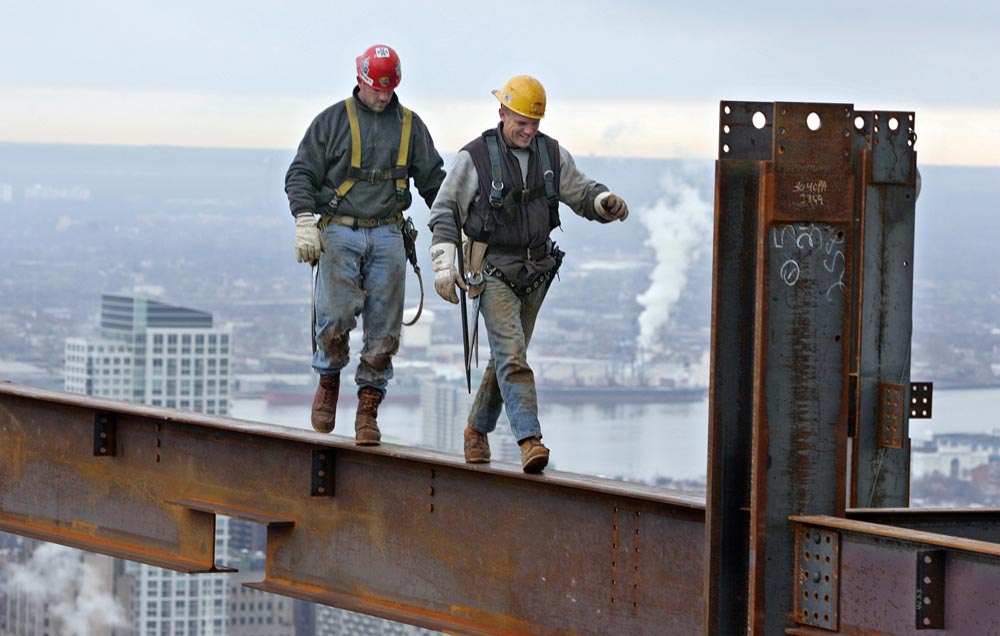Ironworkers walk on an interior beam on the 47th floor of the Comcast Center.