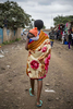 A woman carries her baby as she walks through the market in Dandora, Kenya.  (Photo by Barbara Johnston/University of Notre Dame) 