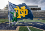 October 21, 2020; Conal Fagan the football Leprechaun with the ND flag in Notre Dame Stadium.  (Photo by Barbara Johnston/University of Notre Dame)