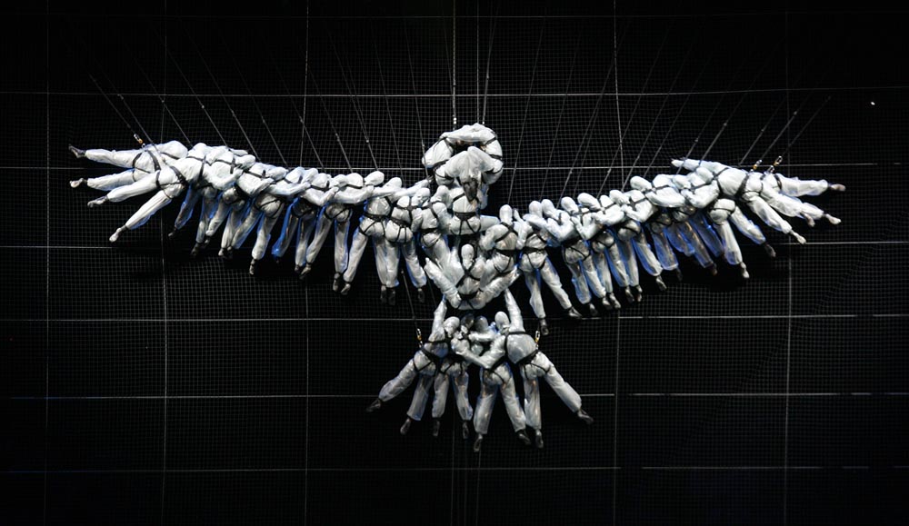 Acrobats, floating on system of counterweights, nets and balances, come together in shape of a dove, the universal symbol of peace, during the opening ceremonies for the 2006 Winter Olympics, in Turin, Italy. 