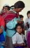 A women and her children attend a dedication service for a new communtiy center in Arequipa.