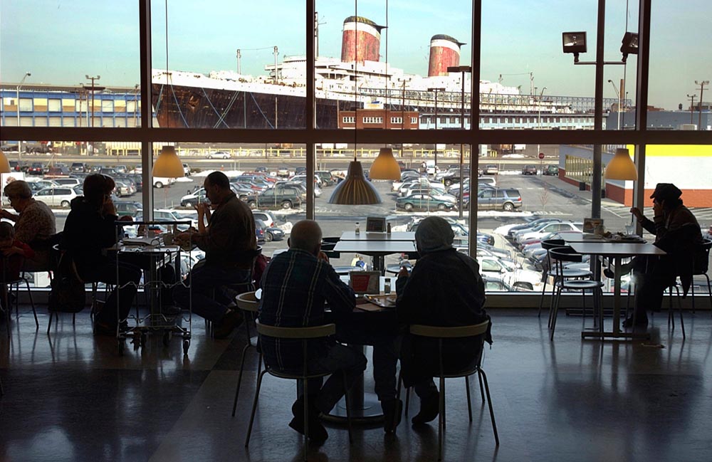 Customers take in the view of the SS United States and Ikea's parking lot at the furniture store's cafe on February 2, 2005.