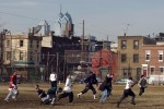 Young men play football on a sunny Sunday afternoon at Capitolo Playground, Ninth and Federal Streets.