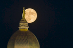 A super moon rises behind the  Golden Dome.