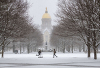 February 13, 2020; Students make their way across South Quad during a snowfall.  (Photo by Barbara Johnston/University of Notre Dame)