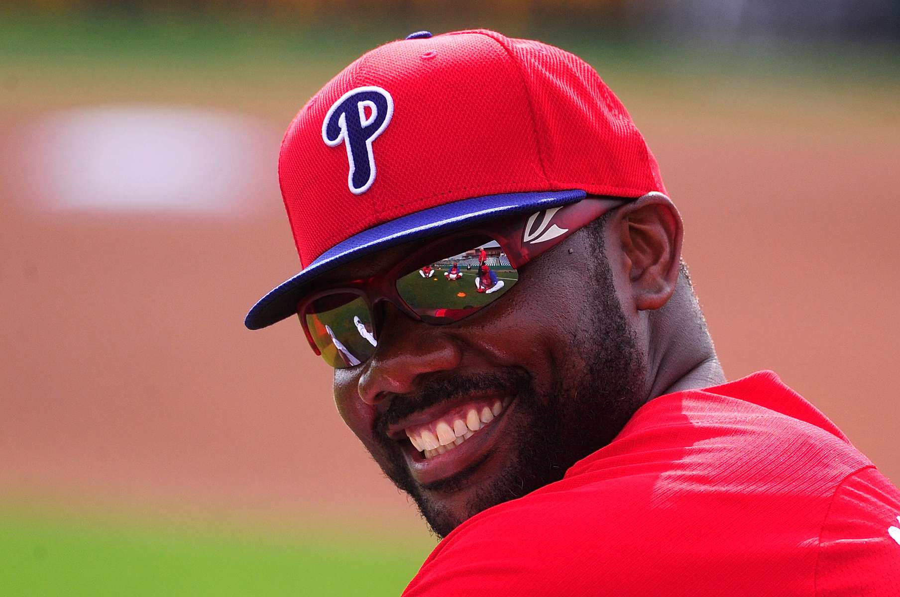 Philadelphia Phillies first baseman Ryan Howard stretches while his teammates are reflected in his glasses before the Toronto Blue Jays play the Phillies in a spring training exhibition game at Bright House Field on Wednesday, February 26, 2014 in Clearwater, Fla.