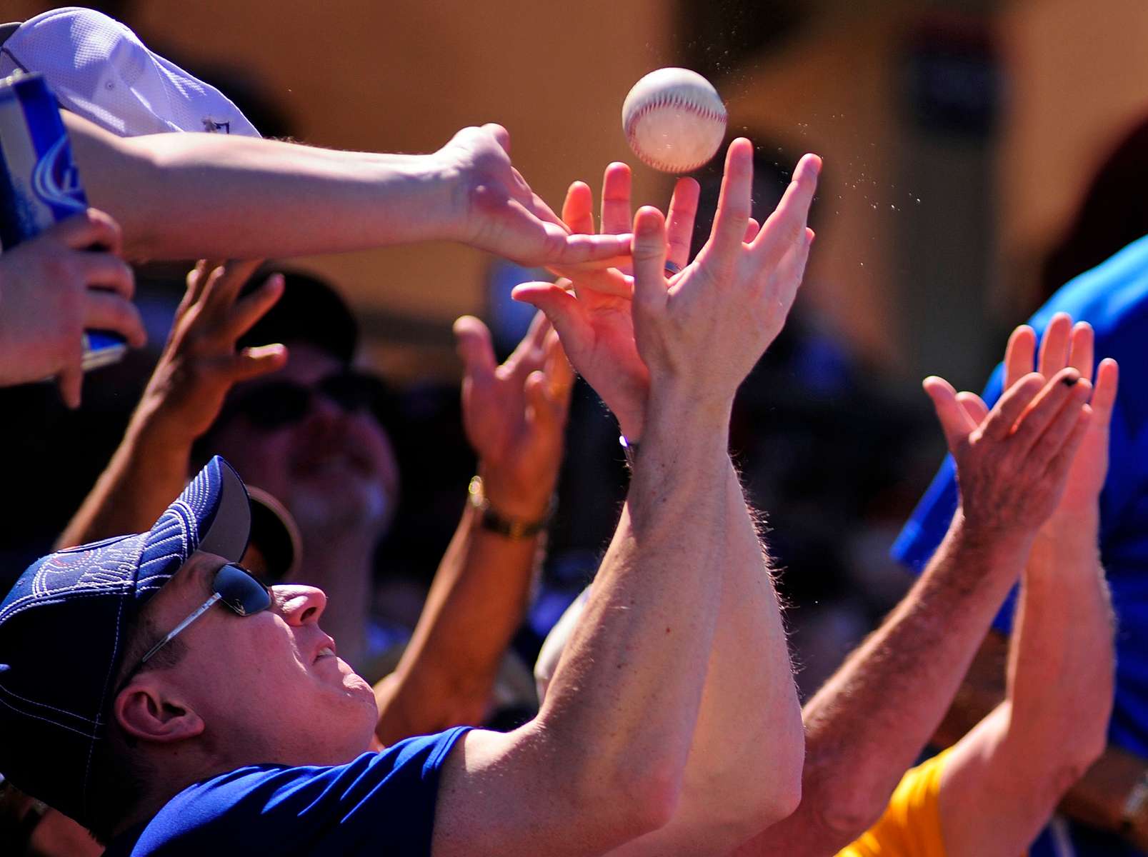 A fan catches a foul ball while the Houston Astros play the Toronto Blue Jays in a spring training exhibition game on Sunday, March 9, 2014 at Osceola County Stadium in Kissimmee, Fla.